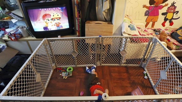 <p>Alexander, 2, a disabled foster child, lies on a mat in a playpen at his Philadelphia foster home. The nation’s affordable housing crisis may be contributing to a dearth of available foster families. </p>