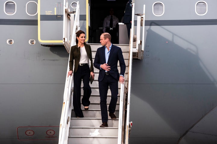 The Duke and Duchess of Cambridge descend from their airplane as they arrive at RAF Akrotiri to celebrate the upcoming Christmas holiday. 