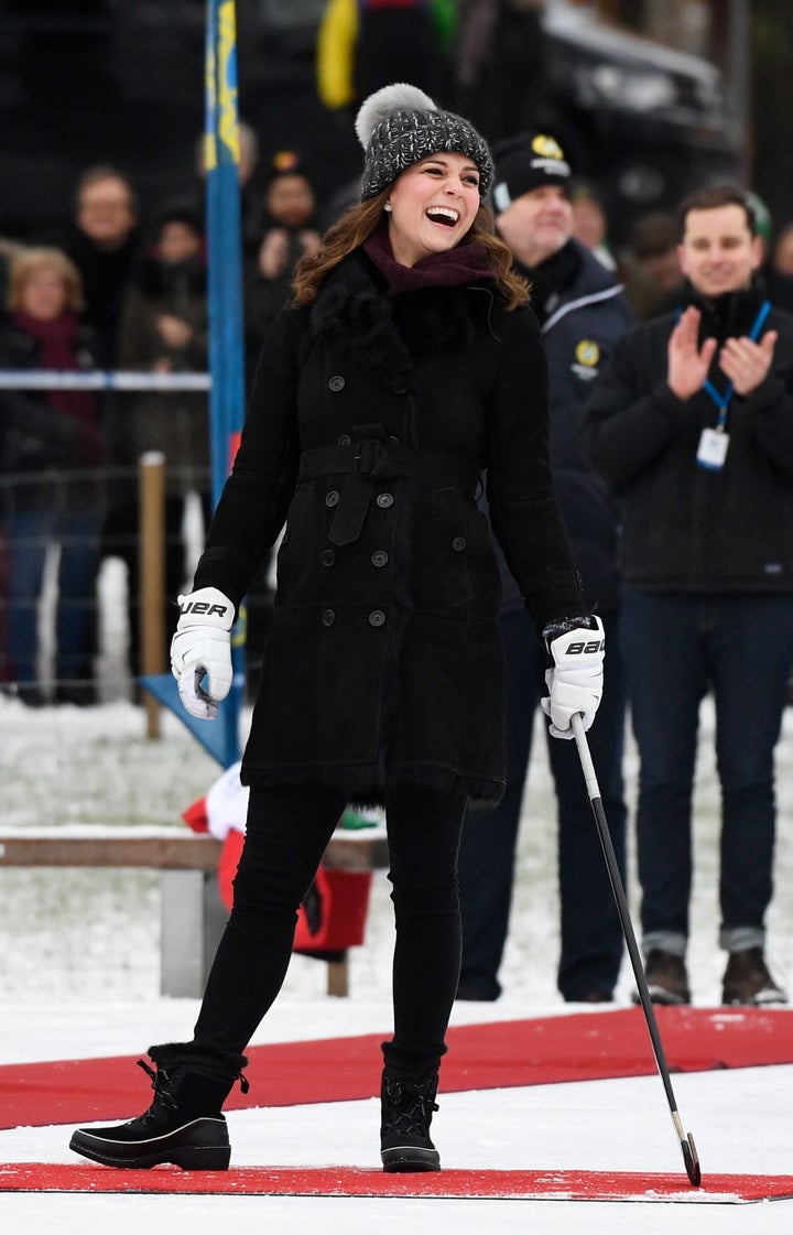 The Duchess of Cambridge laughs as she tries out the game of bandy during a meeting with a group of local bandy players on the ice in Stockholm.