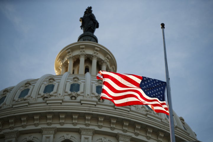 An American flag flies at half-staff at the U.S. Capitol in Washington on Monday, following the death of former President George H.W. Bush.