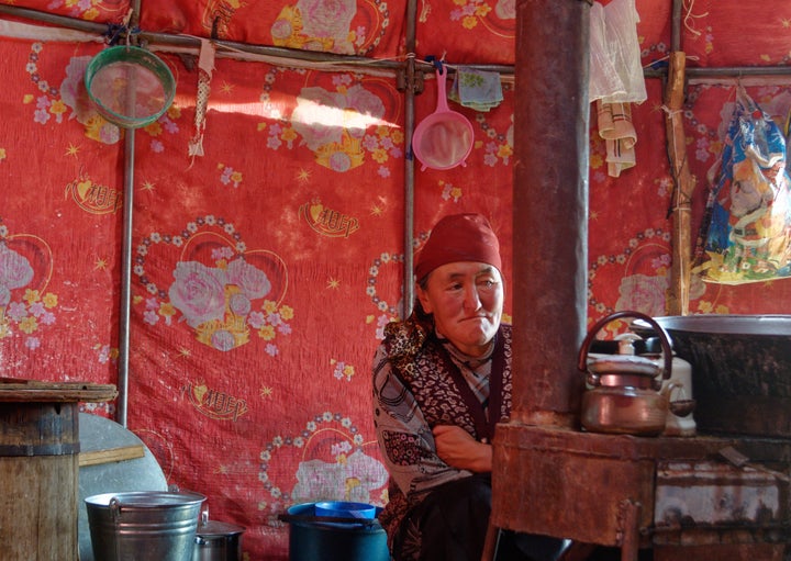 Bukeshova Urmatgul Kachkynovna inside her yurt in Kyrgyzstan. The daughter of a nomadic herder, she remembers traveling great