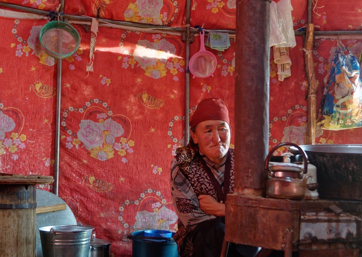 Bukeshova Urmatgul Kachkynovna inside her yurt in Kyrgyzstan. The daughter of a nomadic herder, she remembers traveling great distances annually with her family.