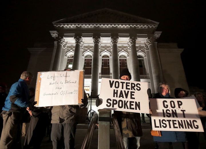 Opponents of an extraordinary session bill submitted by Wisconsin Republican legislators gather for a rally outside the state Capitol in Madison, Dec. 3, 2018.