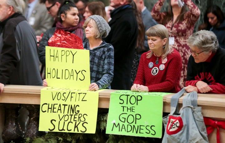 Demonstrators in Wisconsin's state Capitol in Madison protest GOP lawmakers' efforts to curb Democrats' power before the newl