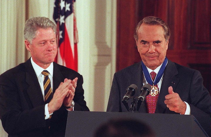 Dole reacts after receiving the Presidential Medal of Freedom from President Bill Clinton at the White House in 1997.