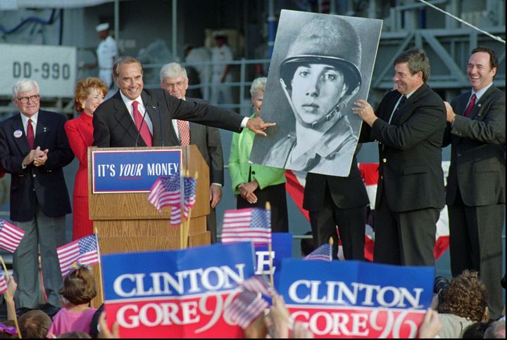Dole points to a picture of himself as a 20-year-old Army private during a rally for himself and presidential running mate Jack Kemp in San Diego in 1996.