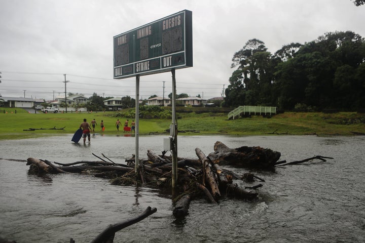 Floodwaters surround a baseball scoreboard during flooding from Tropical Storm Lane on the Big Island, in Hilo, Hawaii.