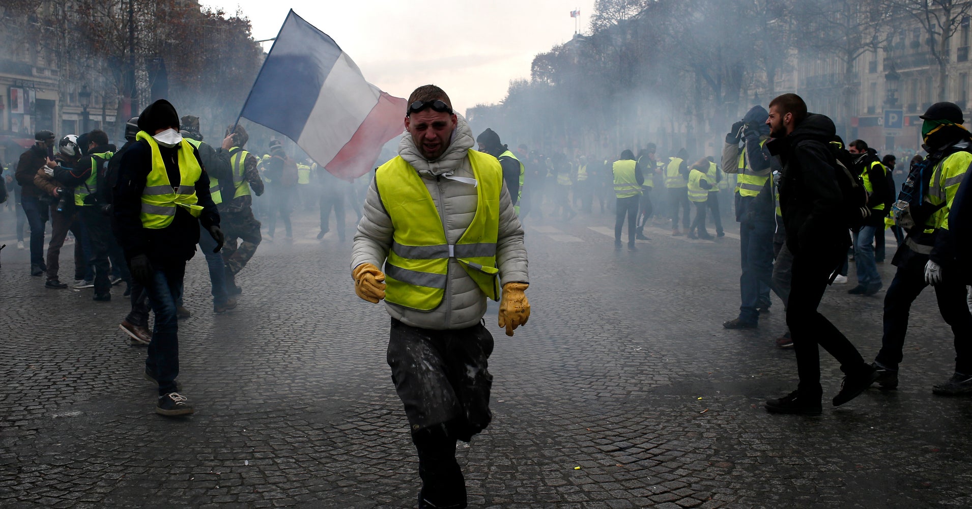 French Police Fire Tear Gas As Yellow-Vested Protesters Swarm Paris