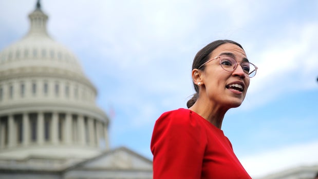 Democratic Representative-elect Alexandria Ocasio-Cortez of New York talks to reporters as she arrives for a class photo with incoming newly elected members of the U.S. House of Representatives on Capitol Hill in Washington, U.S., November 14, 2018. REUTERS/Carlos Barria
