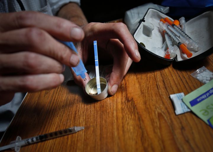 Heroin is prepared using a fentanyl test strip to check for contamination. A new report drilled down to determine the specific drug ― not just the class of drugs ― involved in overdose deaths from 2011 to 2016.
