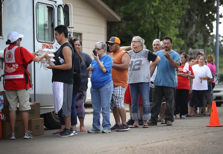 People line up for food and water from the Salvation Army after flooding from Hurricane Harvey in Houston, Sept. 2, 2017. The