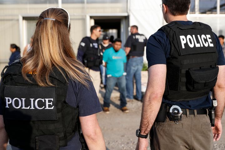 Government agents detain people during an immigration raid in Castalia, Ohio, on June 5. Regular raids are a key part of the Trump administration's crackdown on undocumented immigrants.