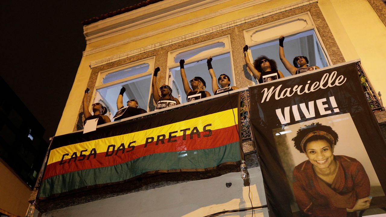 Demonstrators gesture as they protest the shooting of Rio de Janeiro city council member Marielle Franco, in front of the Casa das Pretas (Black Women's House) in Rio de Janeiro.