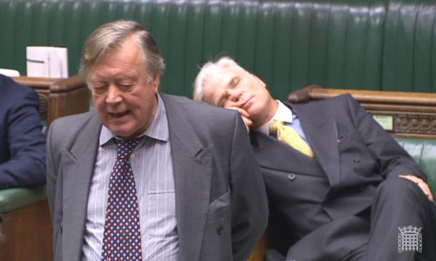 Father of the House Ken Clarke speaking in the House of Commons while Tory MP Sir Desmond Swayne appears to nap 