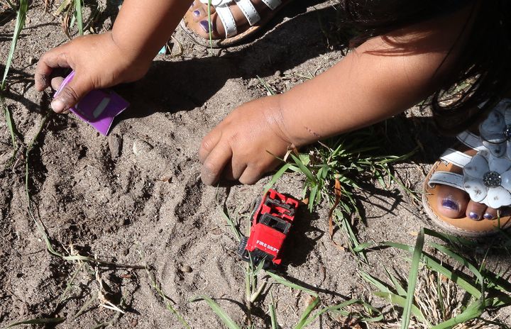 A 2-year-old California girl plays in soil that tested positive for hazardous levels of lead. In a new Illinois pilot study, advocates hope to make environmental factors a stronger determinant for early intervention support.