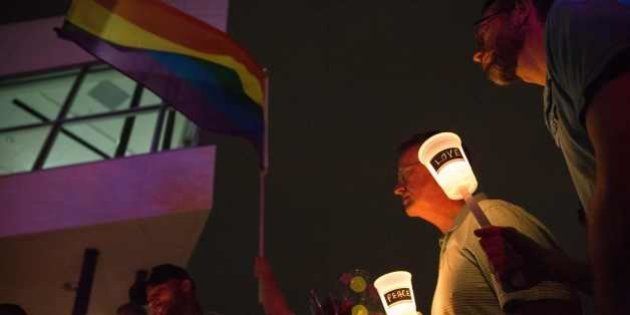 People light candles during a vigil in Dallas, Texas, on June 12, 2016, for victims of the attack at Orlando's Pulse Nightclub in Orlando, Florida.Fifty people died when a gunman allegedly inspired by the Islamic State group opened fire inside a gay nightclub in Florida, in the worst terror attack on US soil since September 11, 2001. / AFP / Laura Buckman (Photo credit should read LAURA BUCKMAN/AFP/Getty Images)