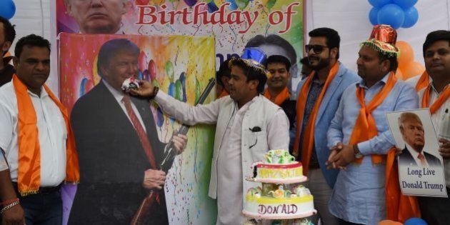 Indian right-wing Hindu activists hold a celebration to mark the 70th birthday of US Republican presidential candidate Donald Trump in New Delhi on June 14, 2016.A far-right Hindu group has previously held prayers in the Indian capital to support the Republican presidential nominee, whose ideas and campaign promises they hail, and with supporters saying he had the potential to 'save humanity'. / AFP / MONEY SHARMA (Photo credit should read MONEY SHARMA/AFP/Getty Images)