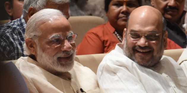 India Bharatiya Janata Party (BJP) President Amit Shah (R) speaks with Prime Minister Narendra Modi during a BJP Parliamentary committee meeting in New Delhi on May 3, 2016, / AFP / Prakash SINGH (Photo credit should read PRAKASH SINGH/AFP/Getty Images)
