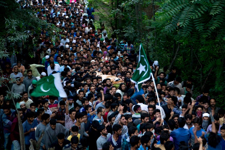 Kashmiri villagers carry the body of Burhan Wani, chief of operations of Indian Kashmir's largest rebel group Hizbul Mujahideen, during his funeral procession in Tral, some 38 Kilometers (24 miles) south of Srinagar. (AP Photo/Dar Yasin)