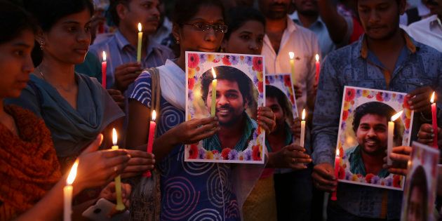 Activist of a Dalit organization participate in a candle light vigil holding photographs of Indian student Rohith Vemula in Hyderabad, India, Wednesday, Jan 20, 2016. (AP Photo/Mahesh Kumar A.)