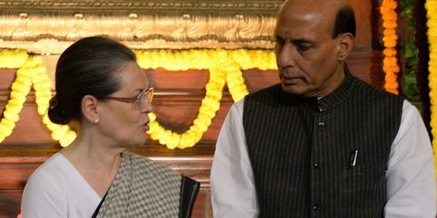 Indian Congress Party President and wife of former Indian prime minister Rajiv Gandhi, Sonia Gandhi (L) talks with Bhartiya Janata Party Leader and Home Minister Rajnath Singh (R) during a remembrance ceremony in Parliament house to mark Gandhi's 71st birth anniversary in New Delhi on August 20, 2015. Rajiv Gandhi was assassinated during electoral campaigning, allegedly by Liberation Tigers of Tamil Eelam (LTTE) rebel separatists, in the town of Sriperumpudur, in the southern state of Tamil Nadu on May 21, 1991. AFP PHOTO/PRAKASH SINGH (Photo credit should read PRAKASH SINGH/AFP/Getty Images)