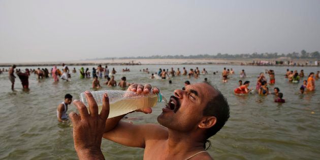 A man drinks water from the Ganga during the Ganga Dussehra festival in Allahabad, June 8, 2014. (AP Photo/Rajesh Kumar Singh)