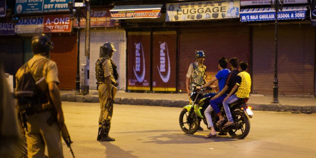 SRINAGAR, KASHMIR, INDIA - JULY 10: Indian government forces a motorcyclist in the City center to stop during a curfew after 21 people were killed and more than 400 Injured on July 10, 2016 in Srinagar, the summer capital of Indian Administered Kashmir. The has been more violence in Indian-administered Kashmir after separatist rebel Burhan Wani, 22, was killed in a gunfight with the Indian army on Friday. (Photo by Yawar Nazir/ Getty Images)