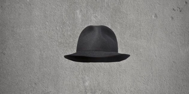 invisible businessman with hat on gray background