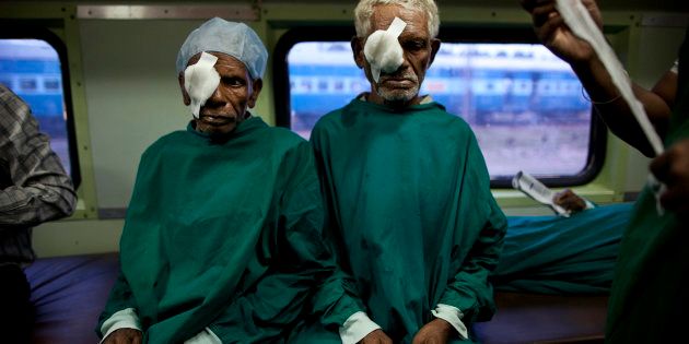 In this July 18, 2011 photo, Indian tribal villagers are bandaged after undergoing cataract surgeries inside the Lifeline Express, a charitable mobile hospital, in Jagdalpur, Chattisgarh state, India. The Lifeline Express, a five-coach train with specialist doctors and operating rooms, is the only hope for the nearly 1.4 million people of this forested eastern area stuck between Maoist violence and government apathy. (AP Photo/Kevin Frayer)