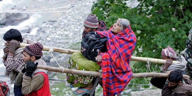 File photo of Kashmiri Muslim nomads carrying a Hindu pilgrim on a palanquin to the holy cave of Lord Shiva in Amarnath, 141 km southeast of Srinagar.