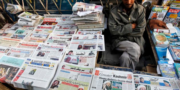 A newspaper vendor displays newspapers with cover stories of Osama bin Laden, in Srinagar, May 3, 2011. Bin Laden was killed in a U.S. special forces assault on a Pakistani compound, then quickly buried at sea, in a dramatic end to the long manhunt for the al Qaeda leader who had been the guiding star of global terrorism. REUTERS/Danish Ismail (INDIAN-ADMINISTERED KASHMIR - Tags: POLITICS CIVIL UNREST OBITUARY SOCIETY)