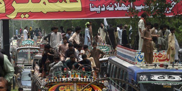 Pakistani supporters of the banned organisation Jamaat-ud-Dawa (JuD) start a march from Lahore to Islamabad as part of a protest to denounce violence by Indian security forces in the Indian-administered Kashmir in Lahore on July 19, 2016. / AFP / ARIF ALI (Photo credit should read ARIF ALI/AFP/Getty Images)