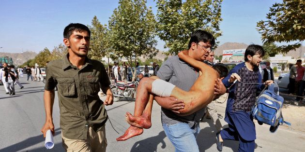 An injured boy is carried to a hospital after an explosion struck a protest in Kabul, Afghanistan, Saturday, July 23, 2016. Witnesses in Kabul say that an explosion struck the protest march by members of Afghanistanâs largely Shiite Hazara ethnic minority group, demanding that a major regional electric power line be routed through their impoverished home province. (AP Photo/Rahmat Gul)