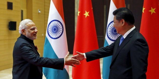 Indian Prime Minister Narendra Modi (L) and Chinese President Xi Jinping shake hands before they hold a meeting in Xian, Shaanxi province, China, May 14, 2015. REUTERS/Kim Kyung-Hoon
