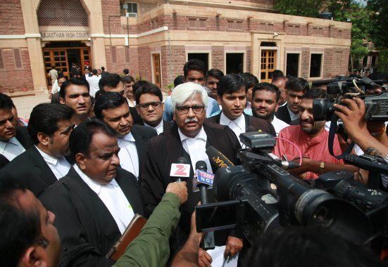 Indian Bollywood actor Salman Khan's lawyer Mahesh Boda (C) speaks with the media outside the Rajasthan High Court after Khan was acquitted in the chinkara poaching cases in Jodhpur on July 25, 2016.