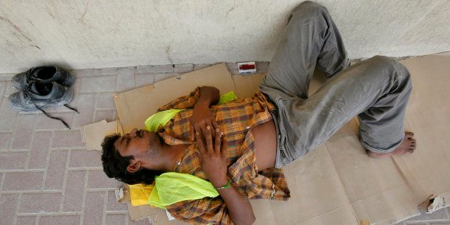 An Indian worker gets some rest during a very hot summer in Dubai, United Arab Emirates September 3, 2007. About 279,000 illegal workers had taken advantage of a three-month amnesty to either regularise their situation or decide to leave the country, local media reported. REUTERS/Ahmed Jadallah (UNITED ARAB EMIRATES)