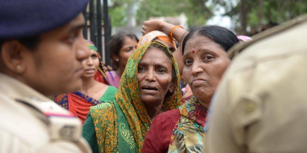 A Dalit woman waits for a relative's release from a police station after protestors were detained by police for damaging vehicles and disturbing peace, at Dholka town, some 40 kms from Ahmedabad on July 21, 2016.