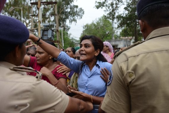 A Dalit tries to barge inside a police station to free supporters who were detained by police for damaging vehicles and disturbing peace, at Dholka town, some 40 kms from Ahmedabad on July 21, 2016.