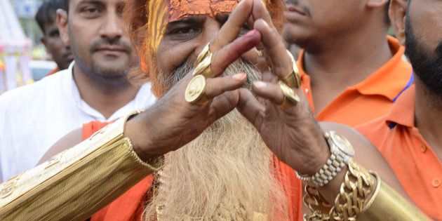 GHAZIABAD, INDIA - JULY 28: 54-year-old Sudhir Makkar, who is popularly known as Golden Baba, wears nearly 12.5 kg of gold during Kanwar Yatra on July 28, 2016 in Ghaziabad, India.