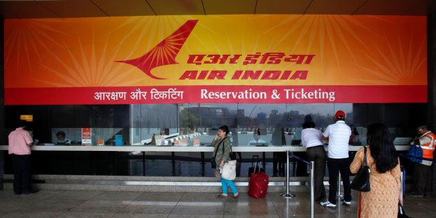 Customers stand at an Air India reservation office at the domestic airport in Mumbai May 8, 2012. Air India has cancelled four international flights after about a 100 pilots called in