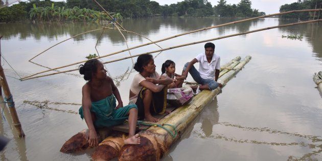 Indian villagers take rest on a raft in the flood-affected Bordiya Kacharigoan village in Assam.
