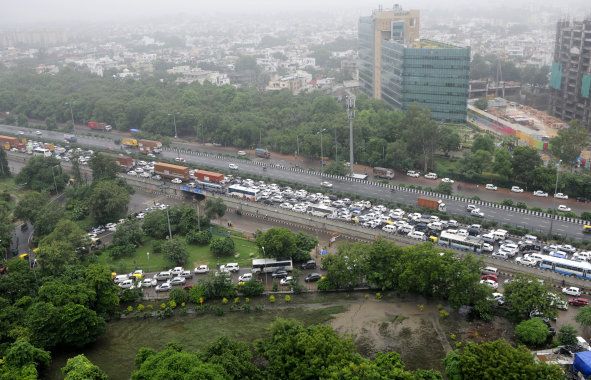 A traffic jam at Signature Tower Chowk, NH8 due to heavy rainfall on 29 July, 2016. Gurgaon Police and Haryana authorities were criticised after waterlogging caused massive gridlocks that paralysed the Millennium City and exposed Indias shoddy urban infrastructure.