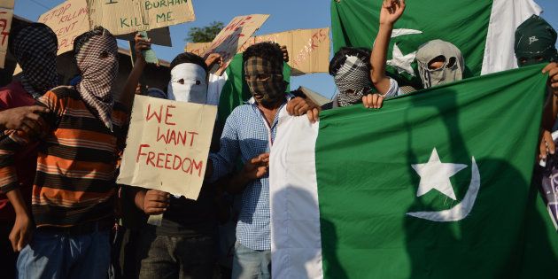 Masked Kashmiri protestors shout pro-Pakistan and pro-freedom slogans during a protest in Srinagar on July 31, 2016.