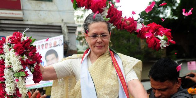 Sonia Gandhi receives floral tributes during the roadshow in Varanasi on August 2, 2016. SANJAY KANOJIA/AFP/Getty Images.