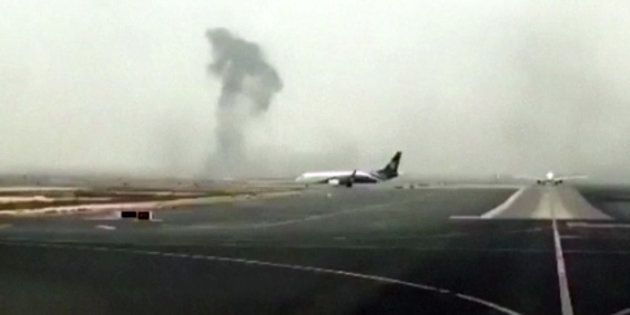 This image is from video shows smoke rising after an Emirates flight crash landed at Dubai International Airport on Wednesday.