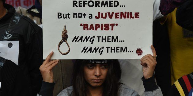 An Indian protester holds a placard during a demonstration against the release of a juvenile rapist in New Delhi.