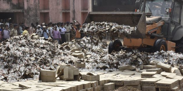 File photo of bottles of country liquor being destroyed on March 31, 2016 on the outskirts of Patna, India.