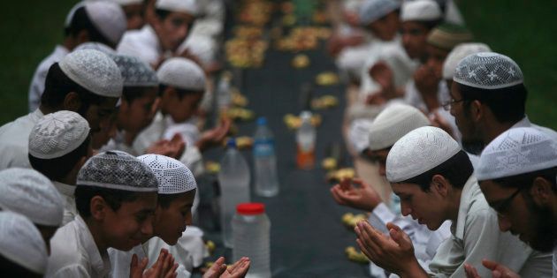 Muslims offer prayers before having their Iftar meal during Ramadan at a madrasa on the outskirts of Jammu August 8, 2012.