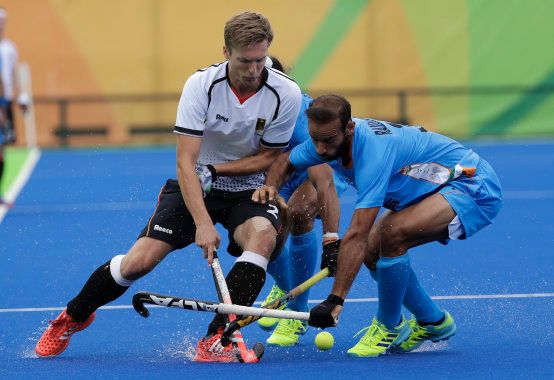 Germany's Mathias Muller, left, fights for the ball against India's Ramandeep Singh, right, during a men's field hockey match against India at 2016 Summer Olympics in Rio de Janeiro. (AP Photo/Hussein Malla)
