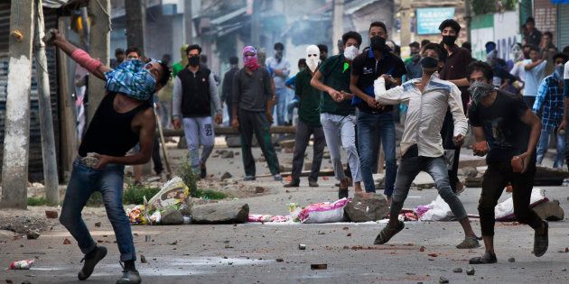Kashmiri Muslim protesters throw stones at Indian security personnel during a protest in Srinagar.